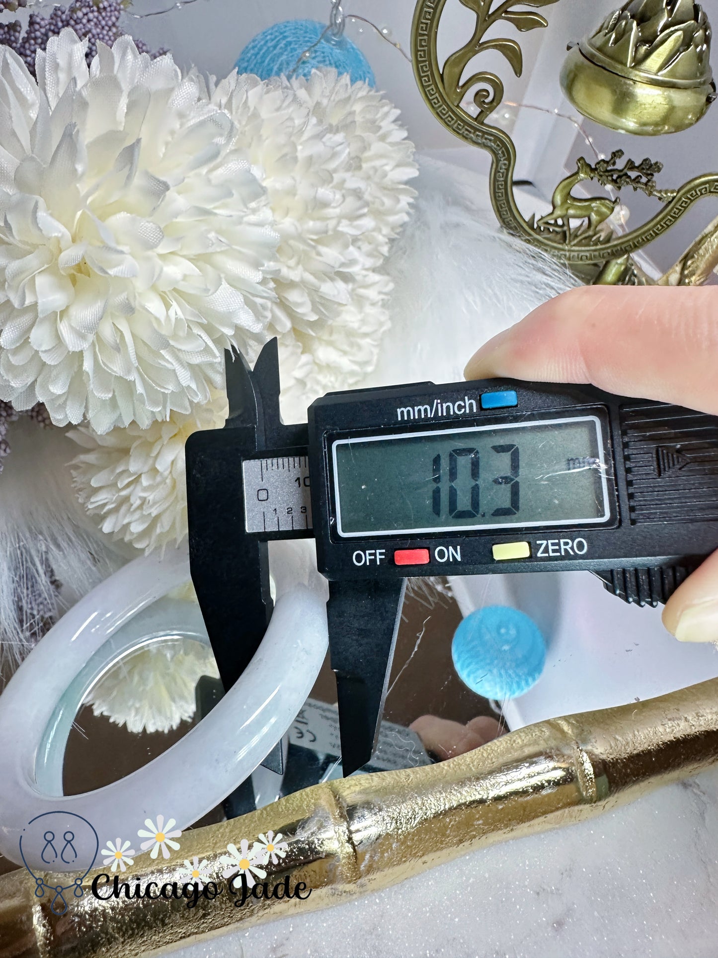 55.3mm Moonlight white with touches of wuji dark spots and green flower natural untreated Burma jadeite jade feicui bangle