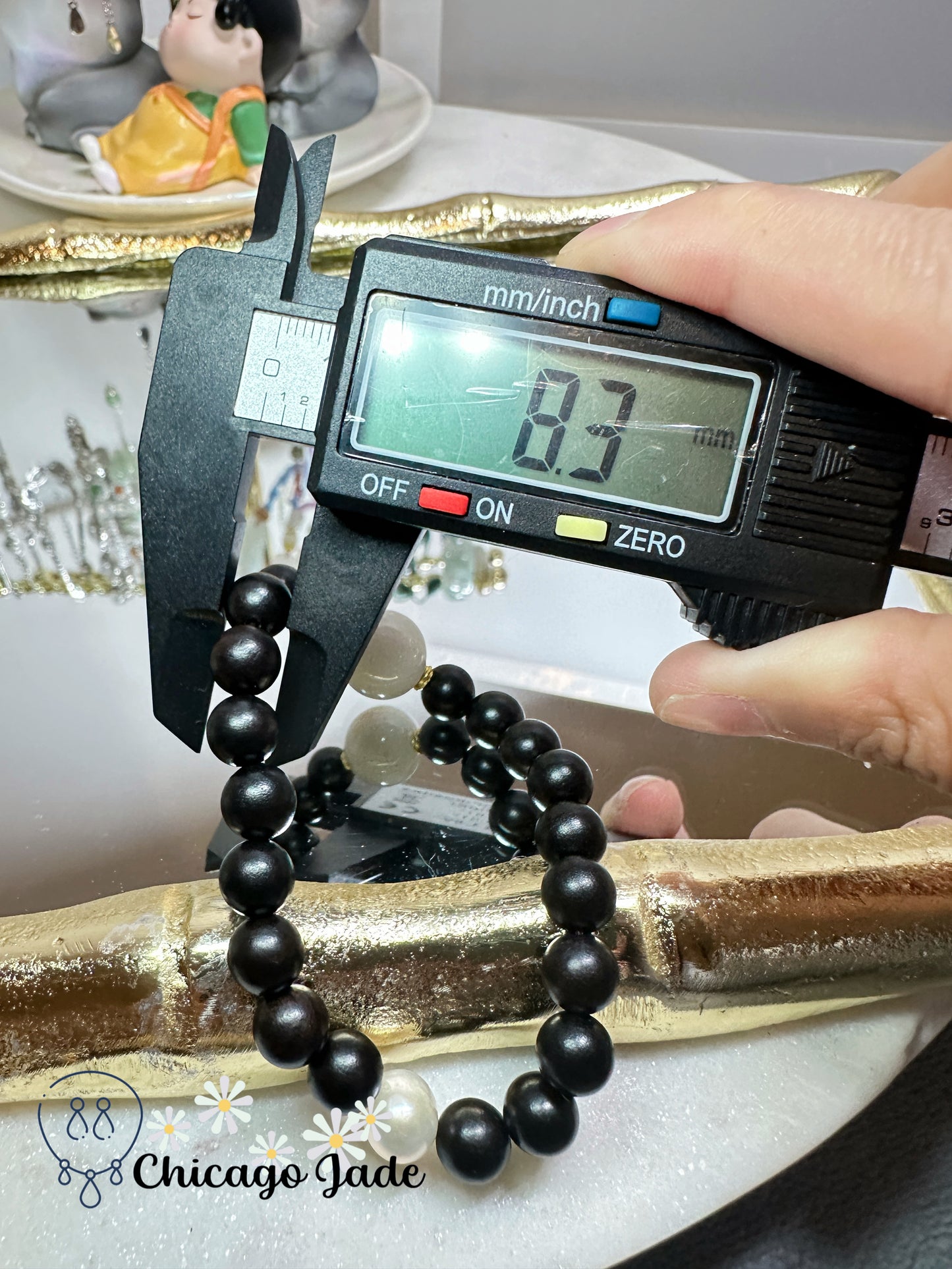 Large round white jadeite jade bead with orange highlights black wood beaded bracelet