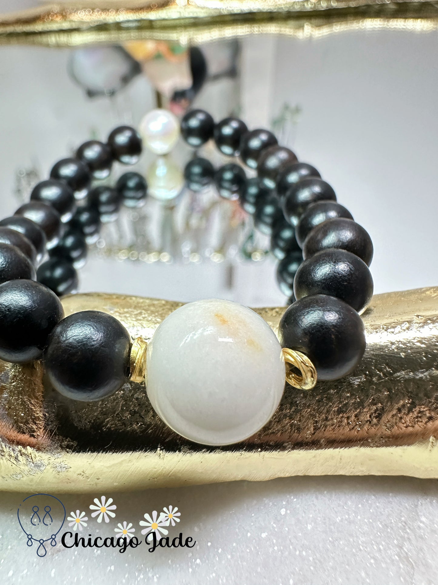 Large round white jadeite jade bead with orange highlights black wood beaded bracelet