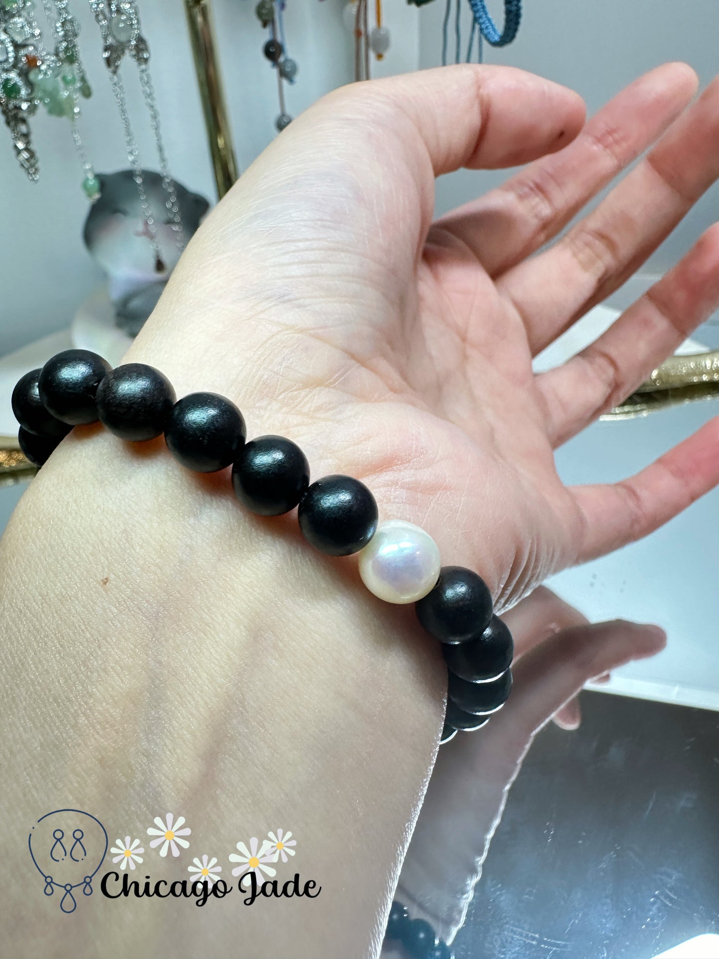 Large round white jadeite jade bead with orange highlights black wood beaded bracelet